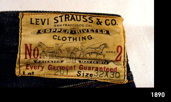 A distressed leather patch featuring LS&Co.'s two-horse pull logo and the text "Levi Strauss & Co. San Francisco, CA. Copper Riveted Clothing" on a pair of Levi's® jeans. 1890.